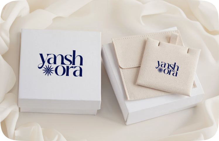 Yansh Ora branded jewellery packaging on cream fabric